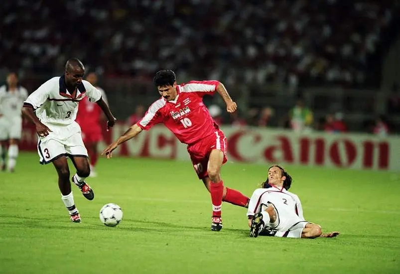 Ali Daei of Iran takes the ball past Eddie Pope and Frankie