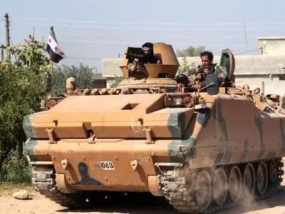 Turkish-led forces advance into Syrian border town, fighting rages