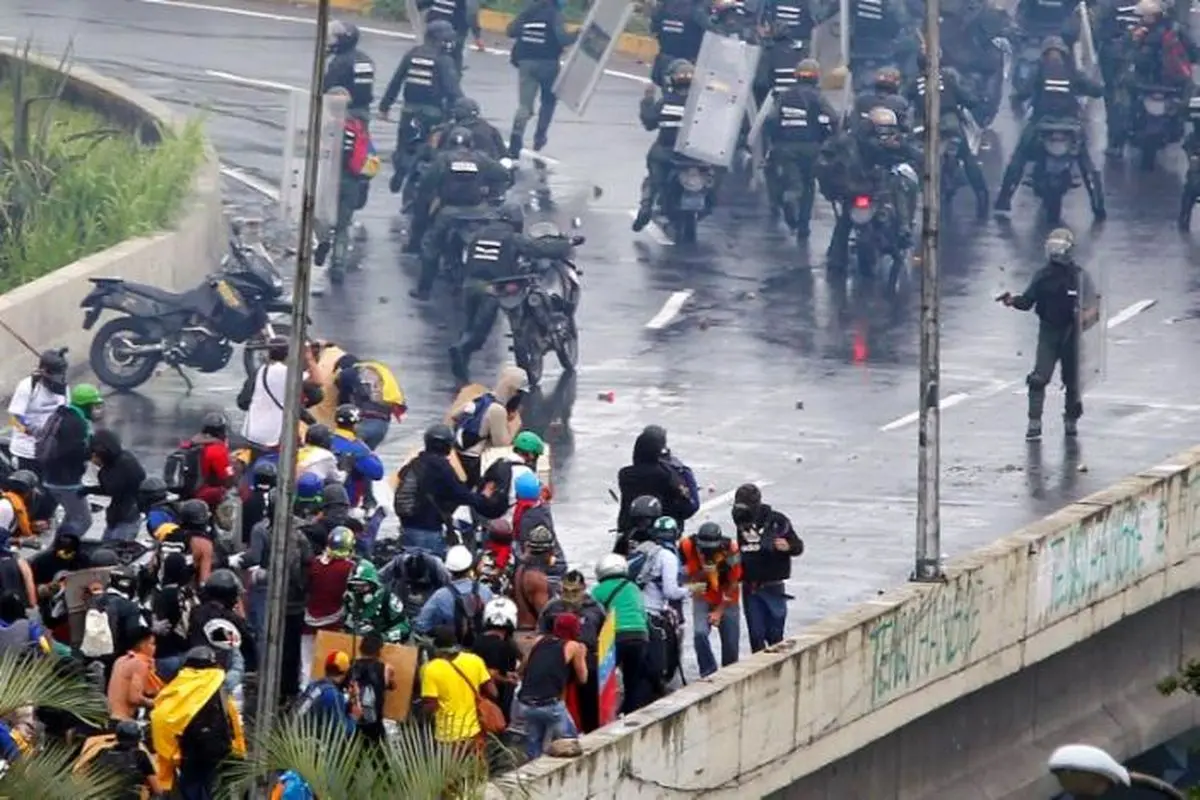 Another youth killed as Venezuela protesters flex muscle in street clashes