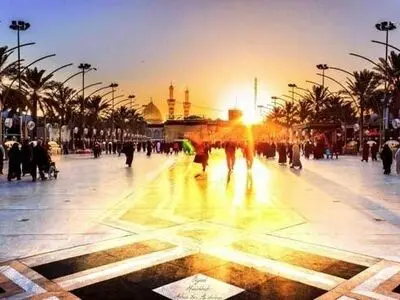 تصویری زیبا از طلوع خورشید بر فراز کربلا "بین الحرمین"