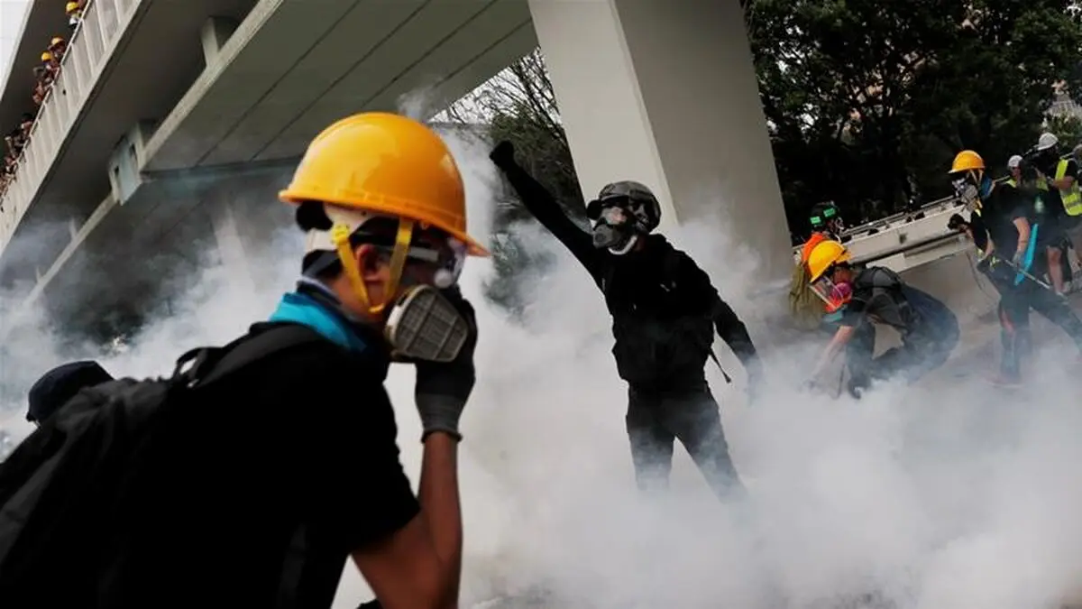 Riot police shield Hong Kong legislature as protests gather against anthem bill