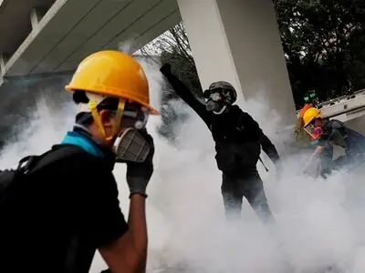 Riot police shield Hong Kong legislature as protests gather against anthem bill
